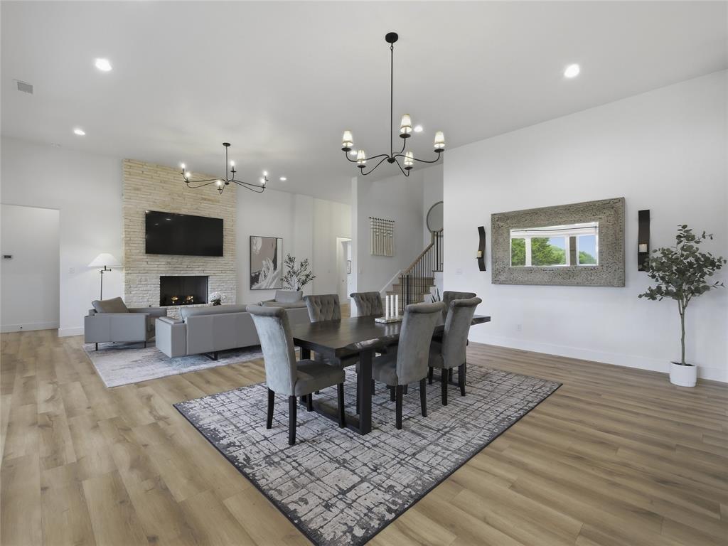 4211 Azalea Way Midlothian, TX 76065 - Photo 13 of 39 Dining area featuring wood-finish flooring, a contemporary chandelier, and a decorative wall mirror