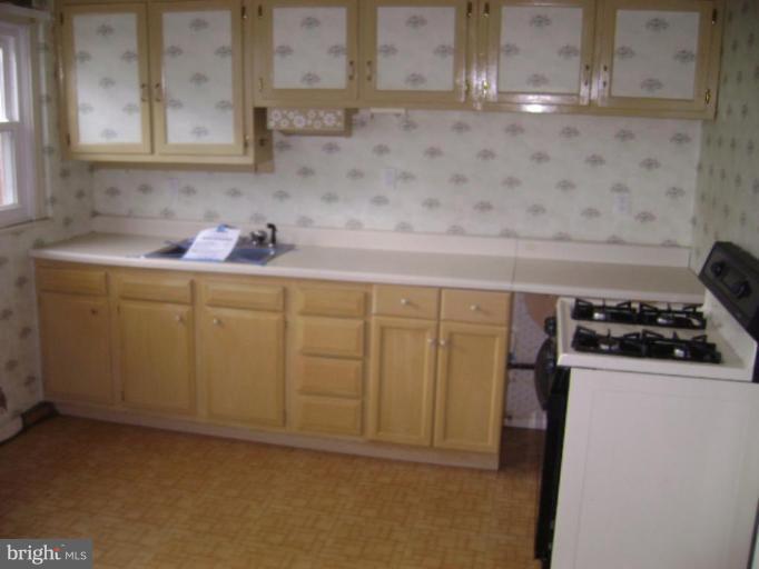 506 Meadow Road Baltimore, MD 21206 - Photo 4 of 10 a kitchen with a sink and cabinets