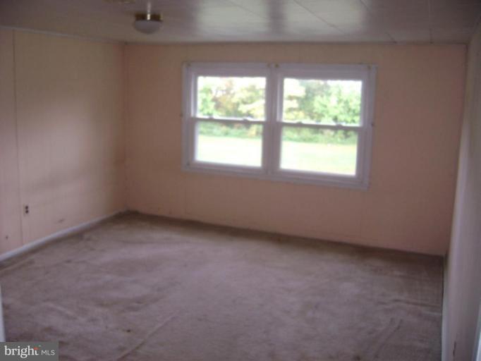 506 Meadow Road Baltimore, MD 21206 - Photo 10 of 10 an empty room with a window