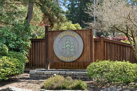 a wooden fence with some trees in the background
