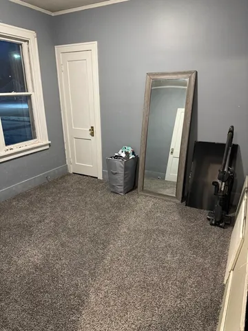 a view of an empty room with workspace and mirror