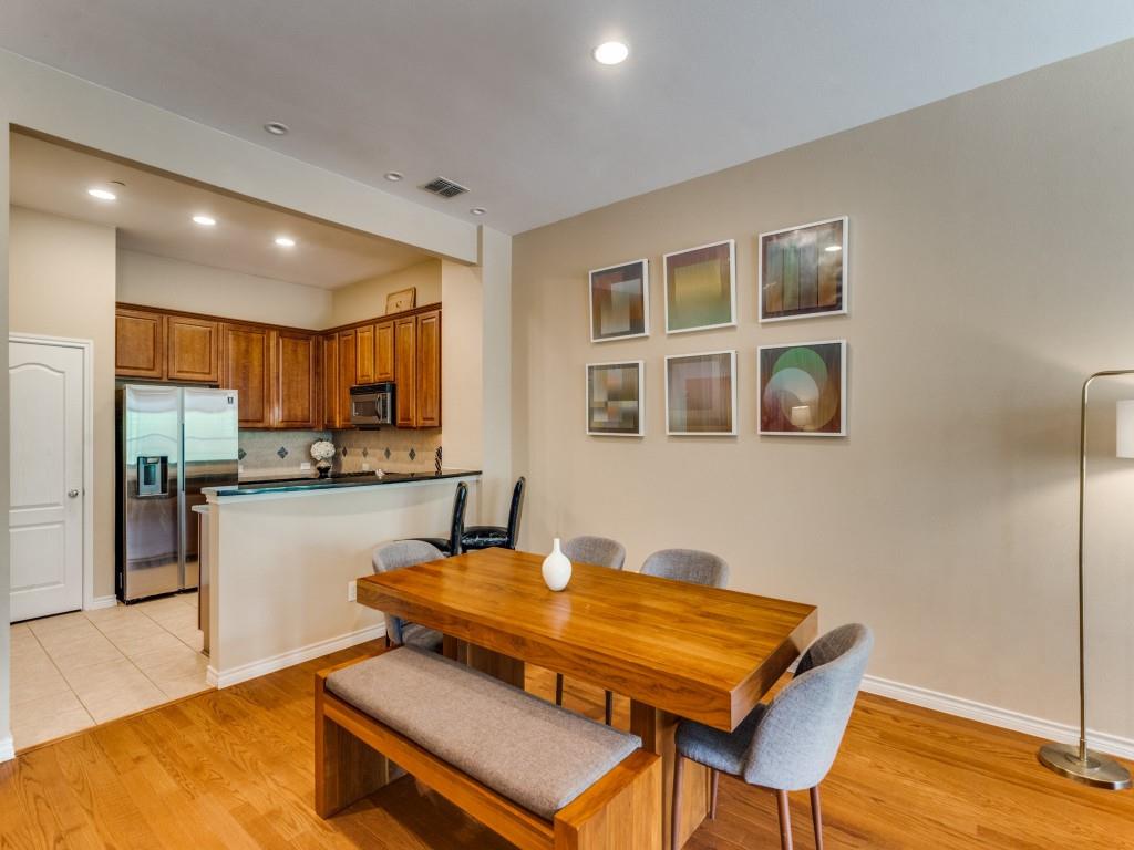 15711 Spectrum Drive, Unit 80 Addison, TX 75001 - Photo 11 of 26 a room with stainless steel appliances kitchen island granite countertop a dining table and chairs
