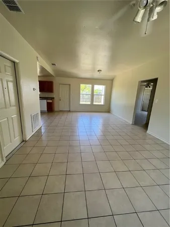 a view of a livingroom with an empty space and a window