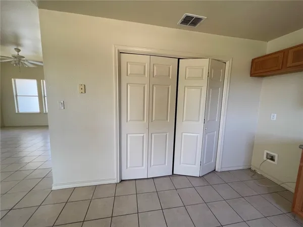 a view of a livingroom with an empty space and a window