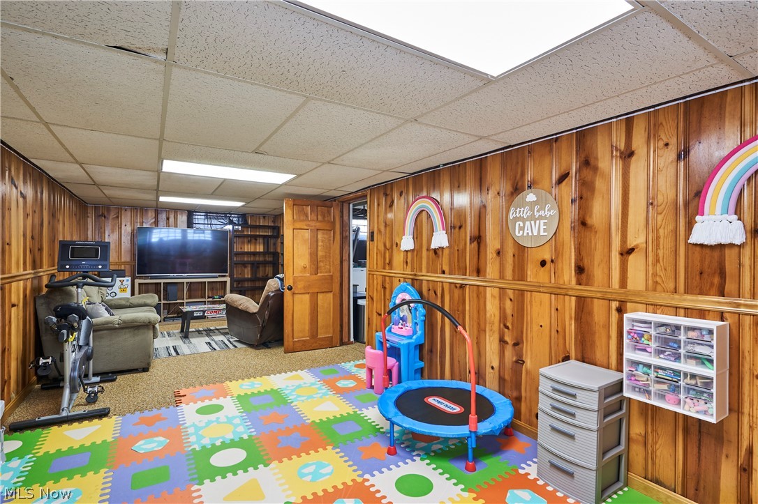 28322 Forest Road Willowick, OH 44095 - Photo 30 of 32 Playroom with a drop ceiling, carpet flooring, and wooden walls