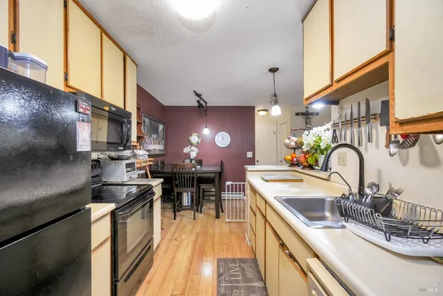 a bedroom with furniture a flat screen tv and a window