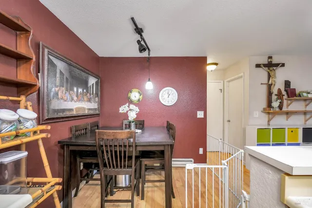 a living room with furniture a walk in closet and wooden floor