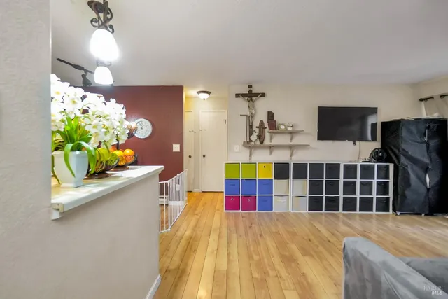 a kitchen with stainless steel appliances a sink a stove and a wooden floors