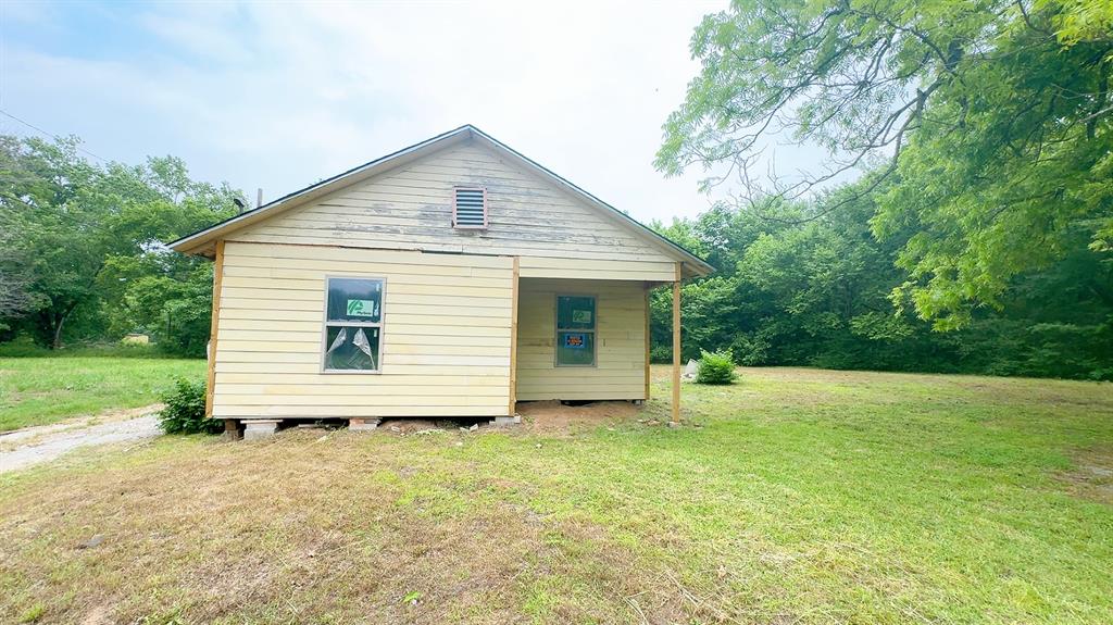 380 3rd Street Northeast Paris, TX 75460 - Photo 1 of 4 a view of a house with a yard