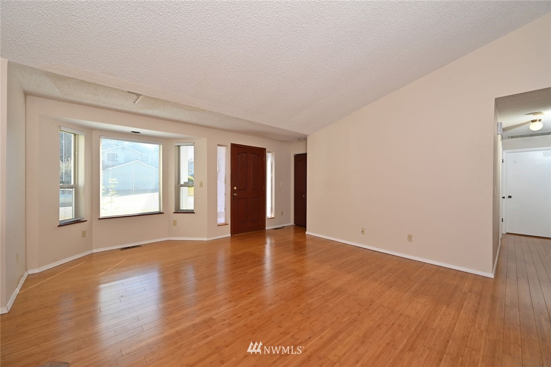 17733 114th Place Southeast Renton, WA 98055 - Photo 4 of 23 a view of an empty room with wooden floor and a window