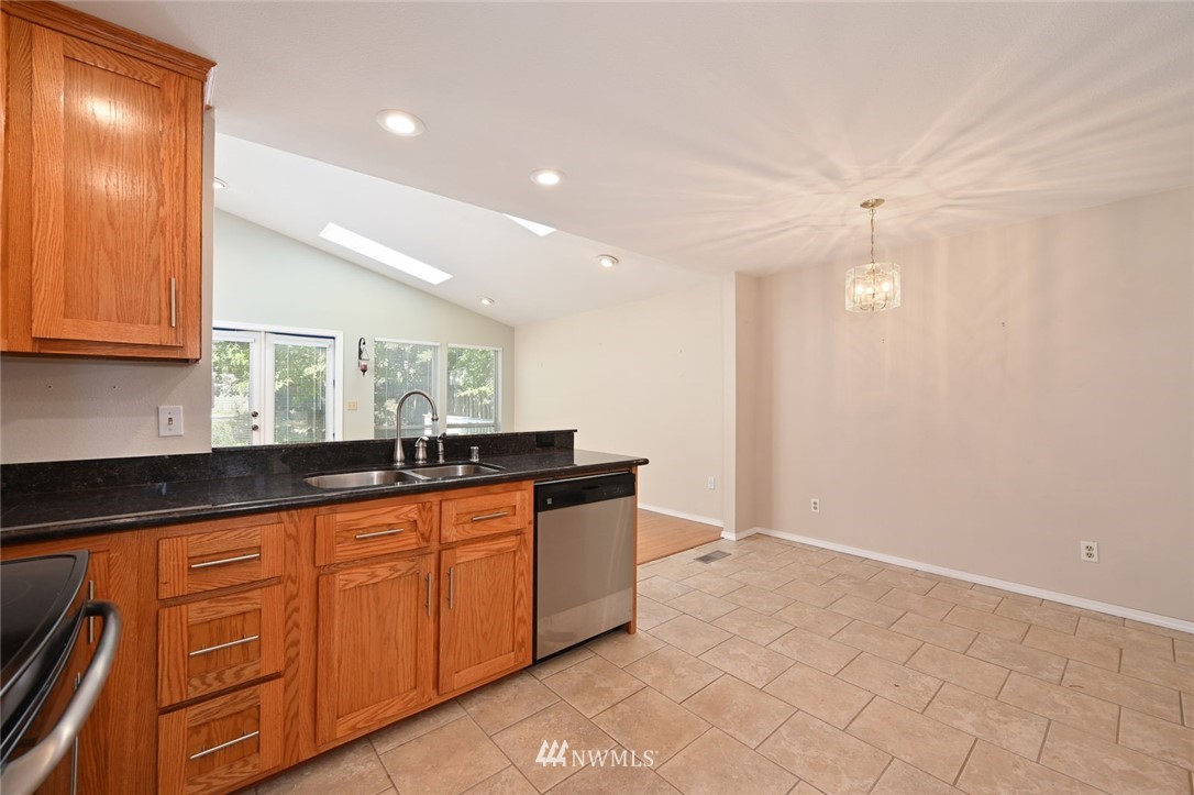 17733 114th Place Southeast Renton, WA 98055 - Photo 6 of 23 a kitchen with granite countertop a sink and cabinets