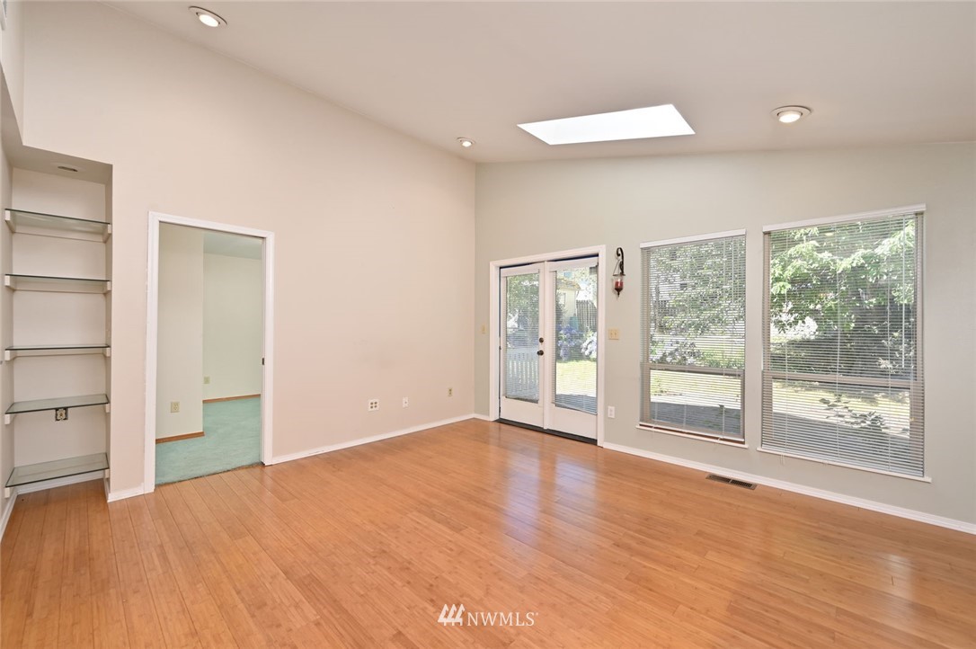 17733 114th Place Southeast Renton, WA 98055 - Photo 10 of 23 a view of an empty room with wooden floor and a window