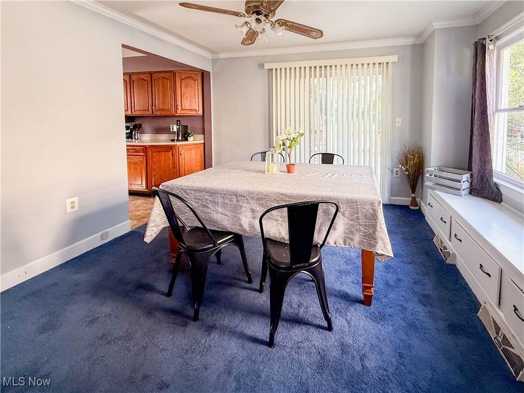 4672 Liberty Road South Euclid, OH 44121 - Photo 5 of 23 Dining area with crown molding, carpet floors, and ceiling fan