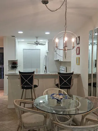 a kitchen with a dining table and chairs