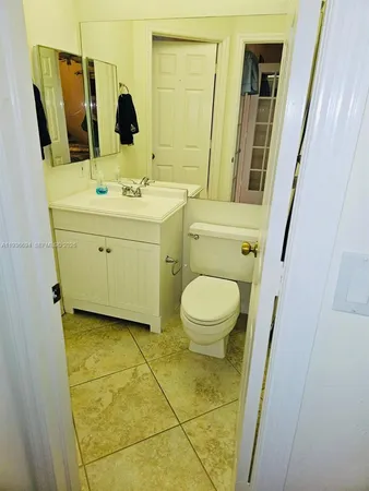 a bathroom with a sink a toilet and mirror