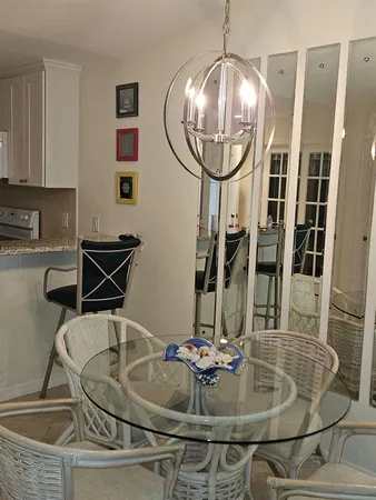 a dining room with table chairs and entryway