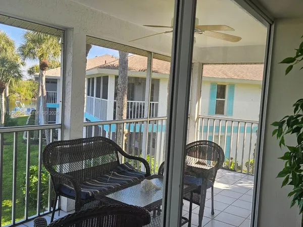 a view of balcony with a potted plant and outdoor seating