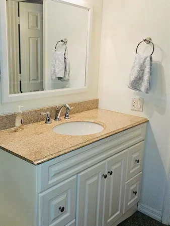 a bathroom with a sink and vanity