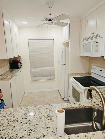 a kitchen with stainless steel appliances a stove a refrigerator and a sink