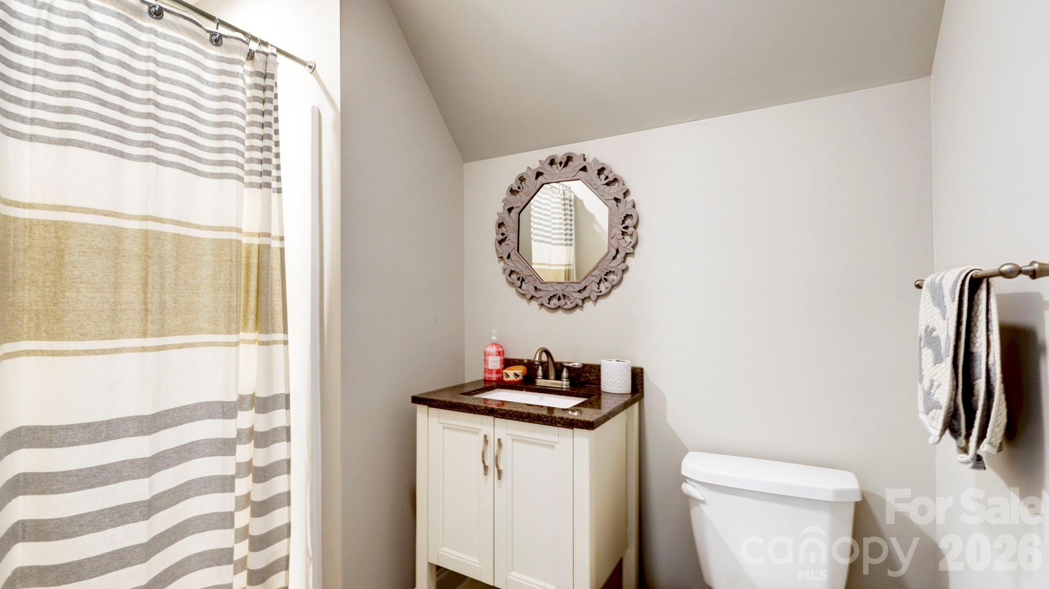 1775 Enochville Road Kannapolis, NC 28081 - Photo 40 of 41 a bathroom with a toilet a sink and a window