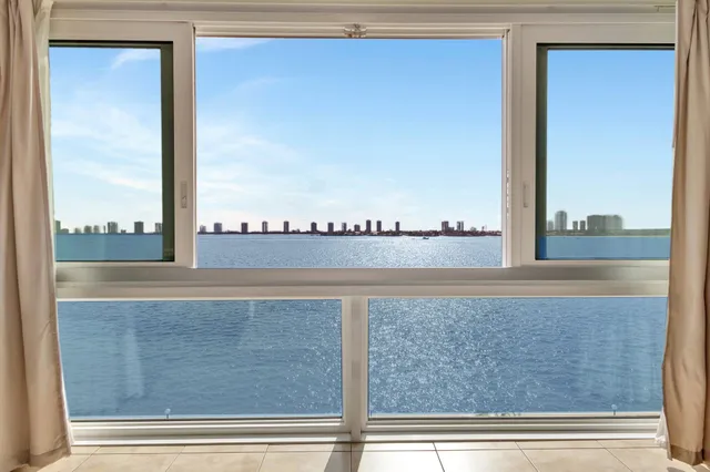 a view of a living room and floor to ceiling window