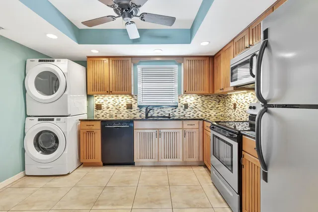 a kitchen with granite countertop a sink and a stove top oven