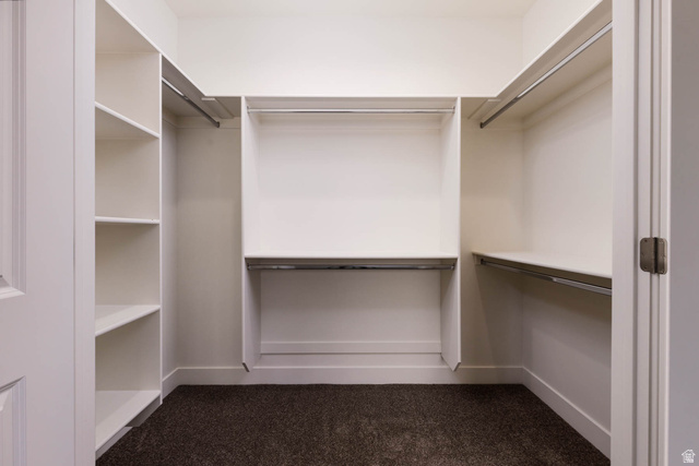 51 West 500 South Monroe, UT 84754 - Photo 21 of 41 Walk-in closet featuring built-in shelving, multiple hanging rods, and ample storage space