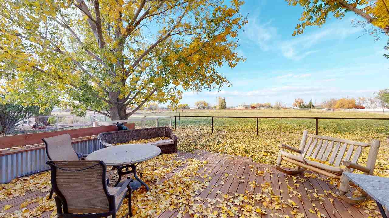 919 21 Road Fruita, CO 81521 - Photo 17 of 27 a view of a balcony with table and chairs and wooden floor