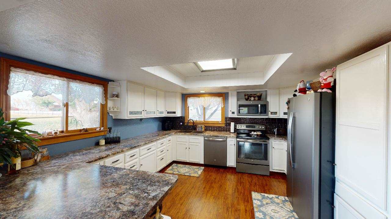 919 21 Road Fruita, CO 81521 - Photo 3 of 27 a kitchen with granite countertop a stove and refrigerator