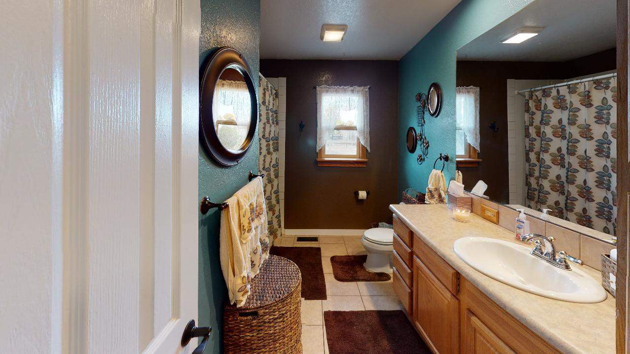 919 21 Road Fruita, CO 81521 - Photo 5 of 27 a bathroom with a sink a mirror and a shower curtain