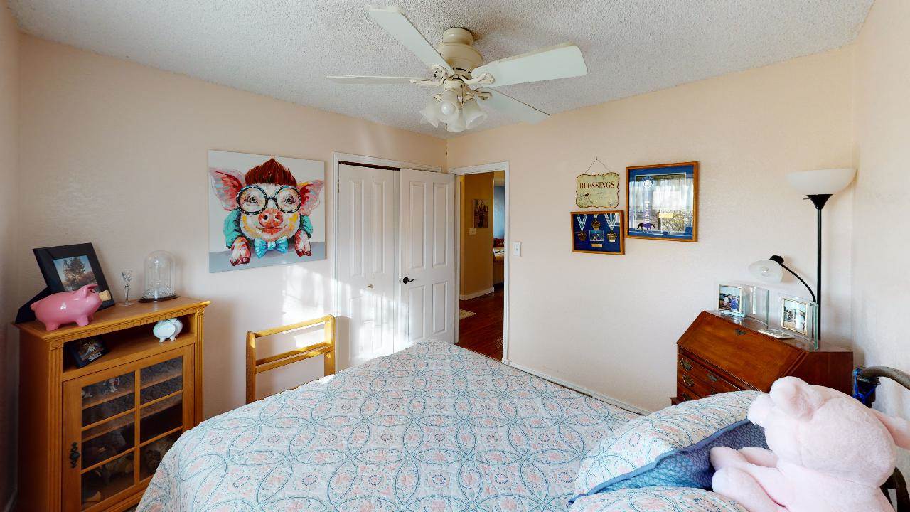 919 21 Road Fruita, CO 81521 - Photo 7 of 27 a bedroom with a bed and a chandelier