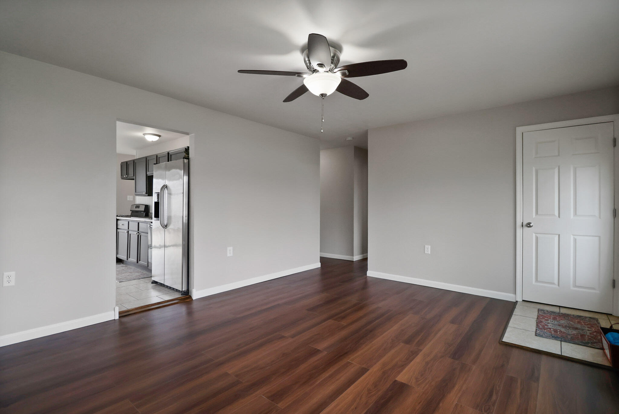 716 Juniper Road Valparaiso, IN 46385 - Photo 6 of 16 a view of an empty room with wooden floor and a ceiling fan