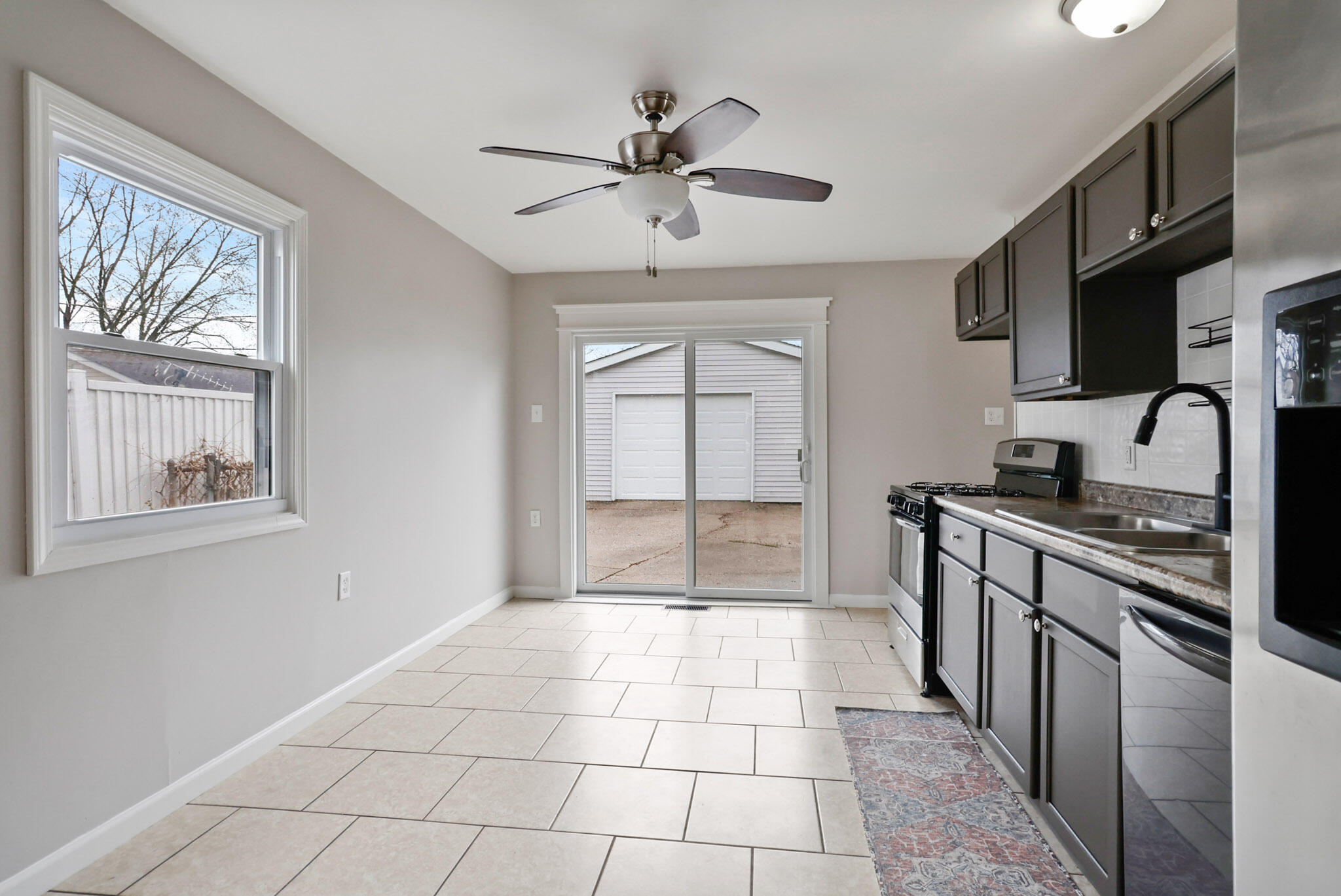 716 Juniper Road Valparaiso, IN 46385 - Photo 8 of 16 a large kitchen with stainless steel appliances granite countertop a stove a sink and a refrigerator
