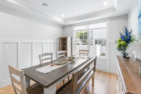 a view of a kitchen area with furniture and wooden floor
