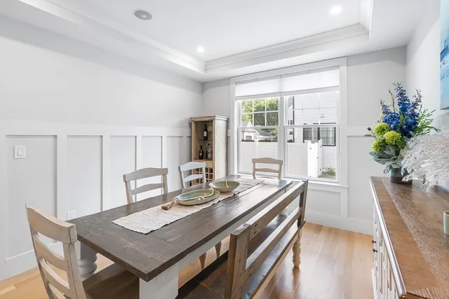 a view of a kitchen area with furniture and wooden floor