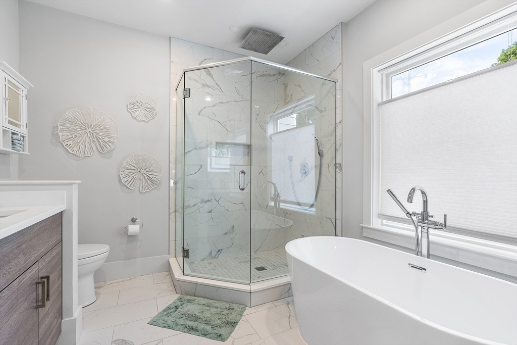 638 Webster Street, Unit 638 Needham, MA 02492 - Photo 18 of 42 a bathroom with a shower a toilet and a sink