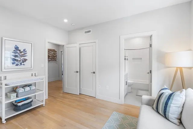 a spacious bedroom with a bed and a couch