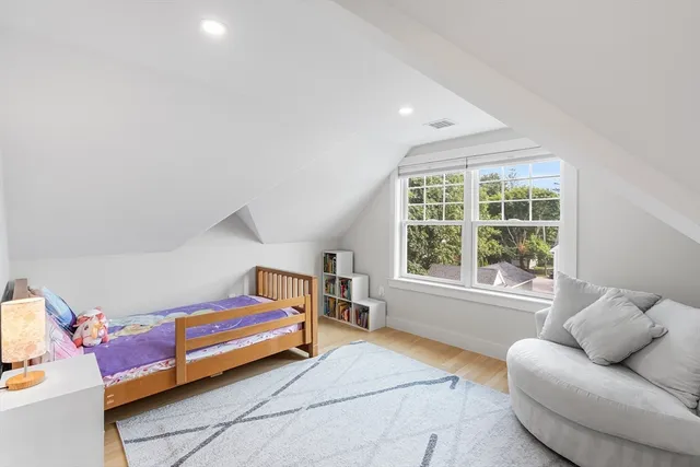 a bedroom with furniture and a large window