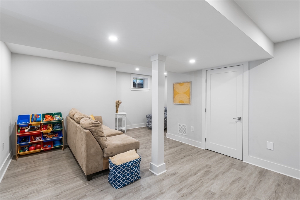 638 Webster Street, Unit 638 Needham, MA 02492 - Photo 33 of 42 a living room with furniture and a wooden floor
