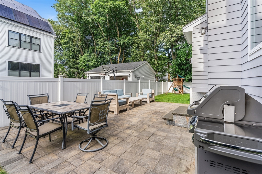 638 Webster Street, Unit 638 Needham, MA 02492 - Photo 36 of 42 a view of a dinning table and chairs in the patio