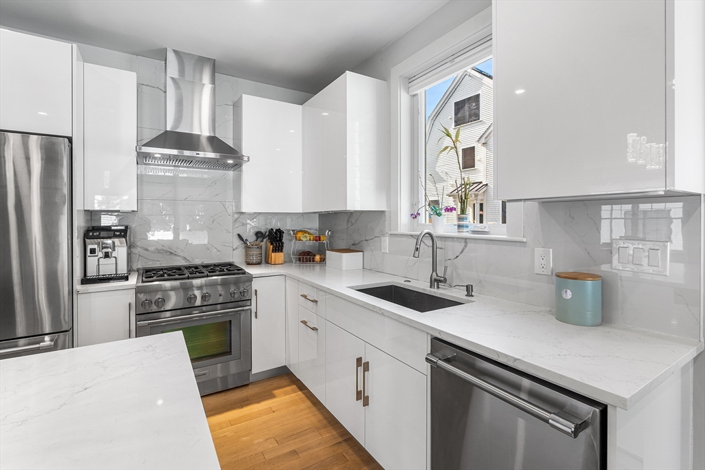 638 Webster Street, Unit 638 Needham, MA 02492 - Photo 7 of 42 a kitchen with a sink stove and refrigerator