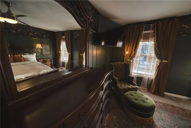 a bed sitting in a room next to a window