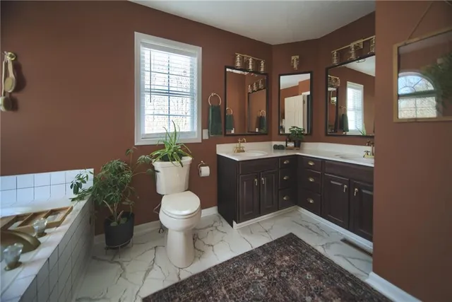 a bathroom with a sink a toilet and a shower curtain