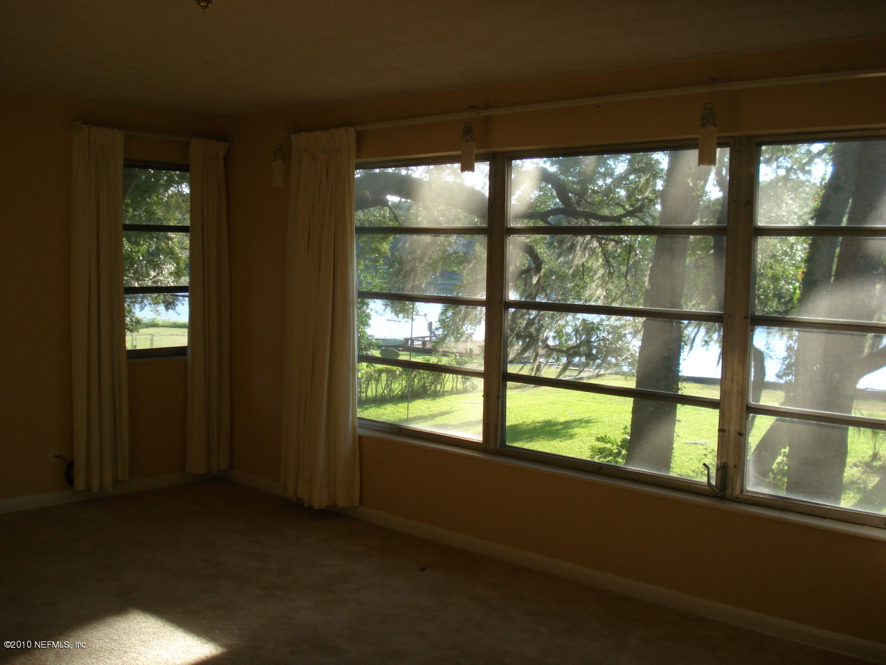 1334 Mayfair Road Jacksonville, FL 32207 - Photo 3 of 4 wooden floor in an empty room with a window