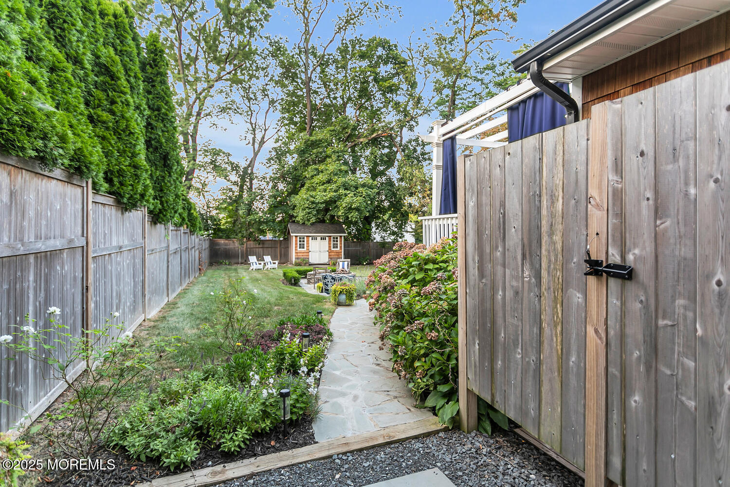303 Hillside Avenue Atlantic Highlands, NJ 07716 - Photo 27 of 103 a view of a pathway of a yard with wooden fence