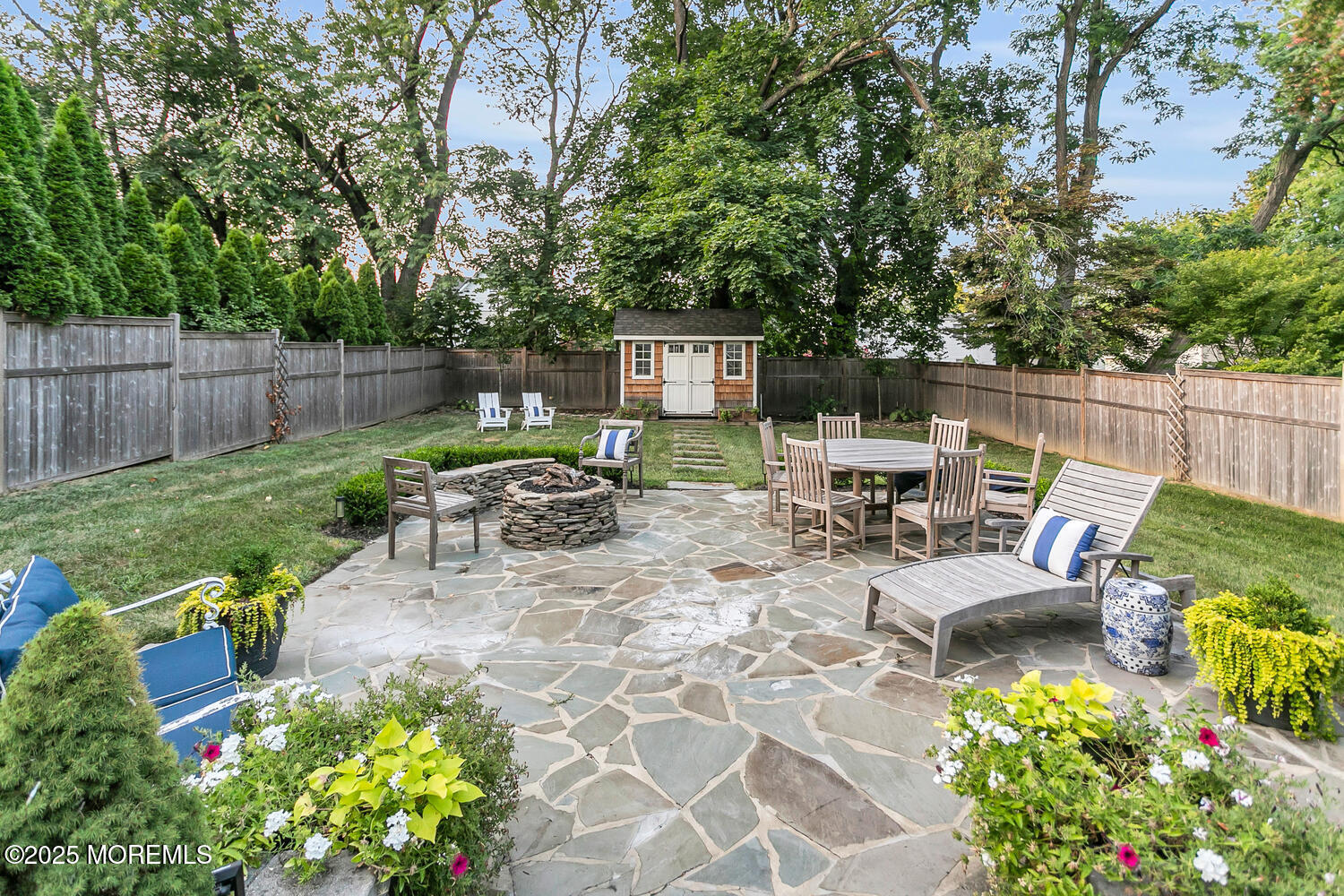 303 Hillside Avenue Atlantic Highlands, NJ 07716 - Photo 33 of 103 a view of a chair and table in the backyard with wooden fence