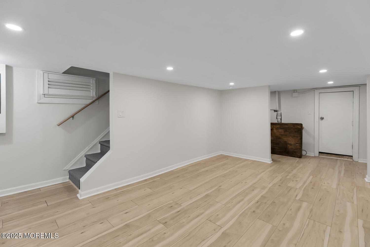 303 Hillside Avenue Atlantic Highlands, NJ 07716 - Photo 36 of 103 a view of an empty room with wooden floor and stairs
