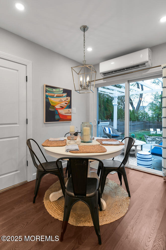 303 Hillside Avenue Atlantic Highlands, NJ 07716 - Photo 44 of 103 a dining room with furniture a chandelier and wooden floor