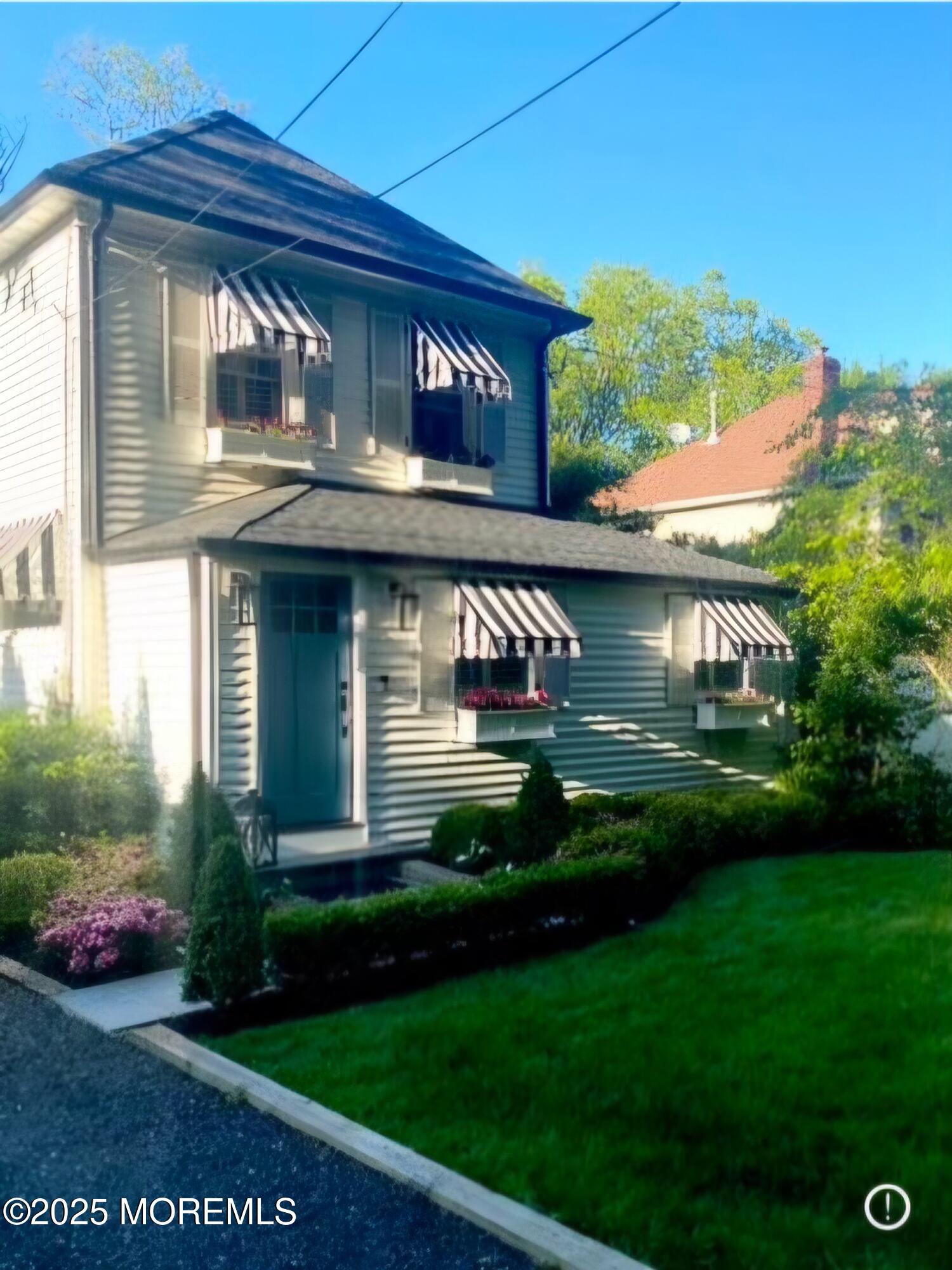 303 Hillside Avenue Atlantic Highlands, NJ 07716 - Photo 96 of 103 a front view of a house with a garden