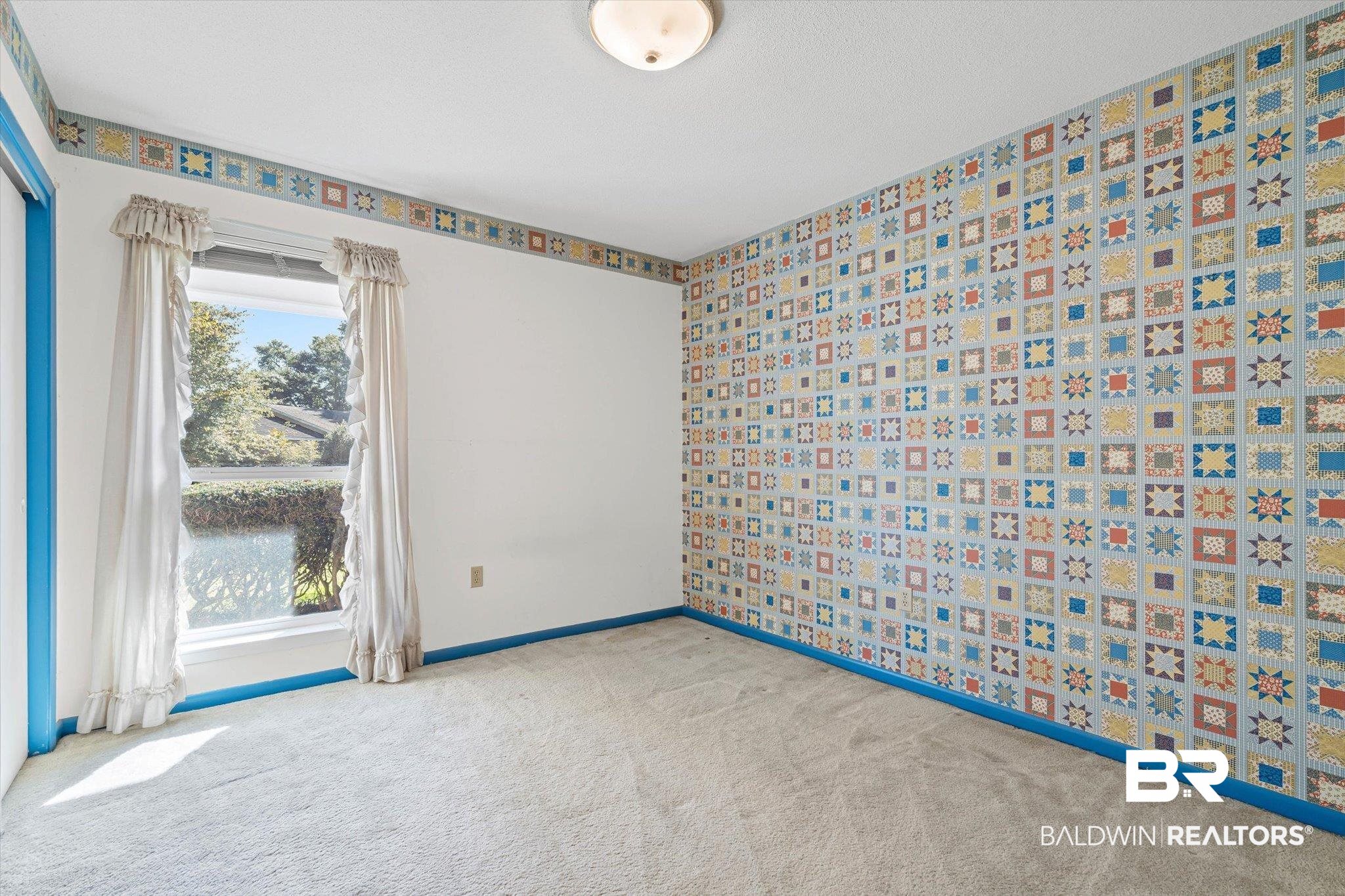 6300 Christopher Drive North Mobile, AL 36609 - Photo 15 of 22 Carpeted spare room featuring wallpapered walls and baseboards